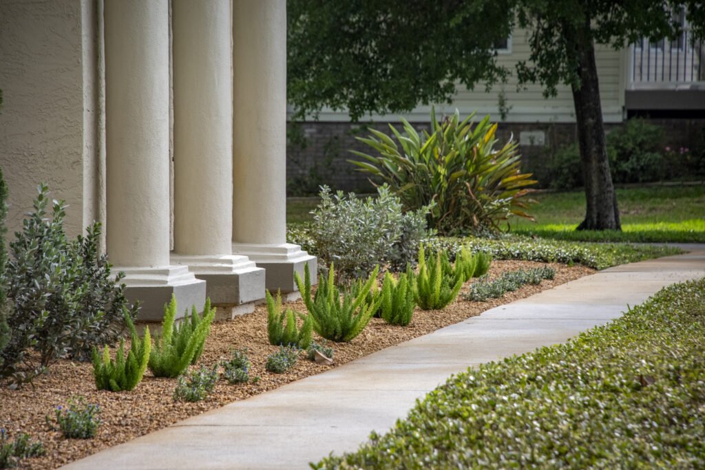 Beautiful landscape in front of large white columns, commercial landscaping by copperhead property maintenance